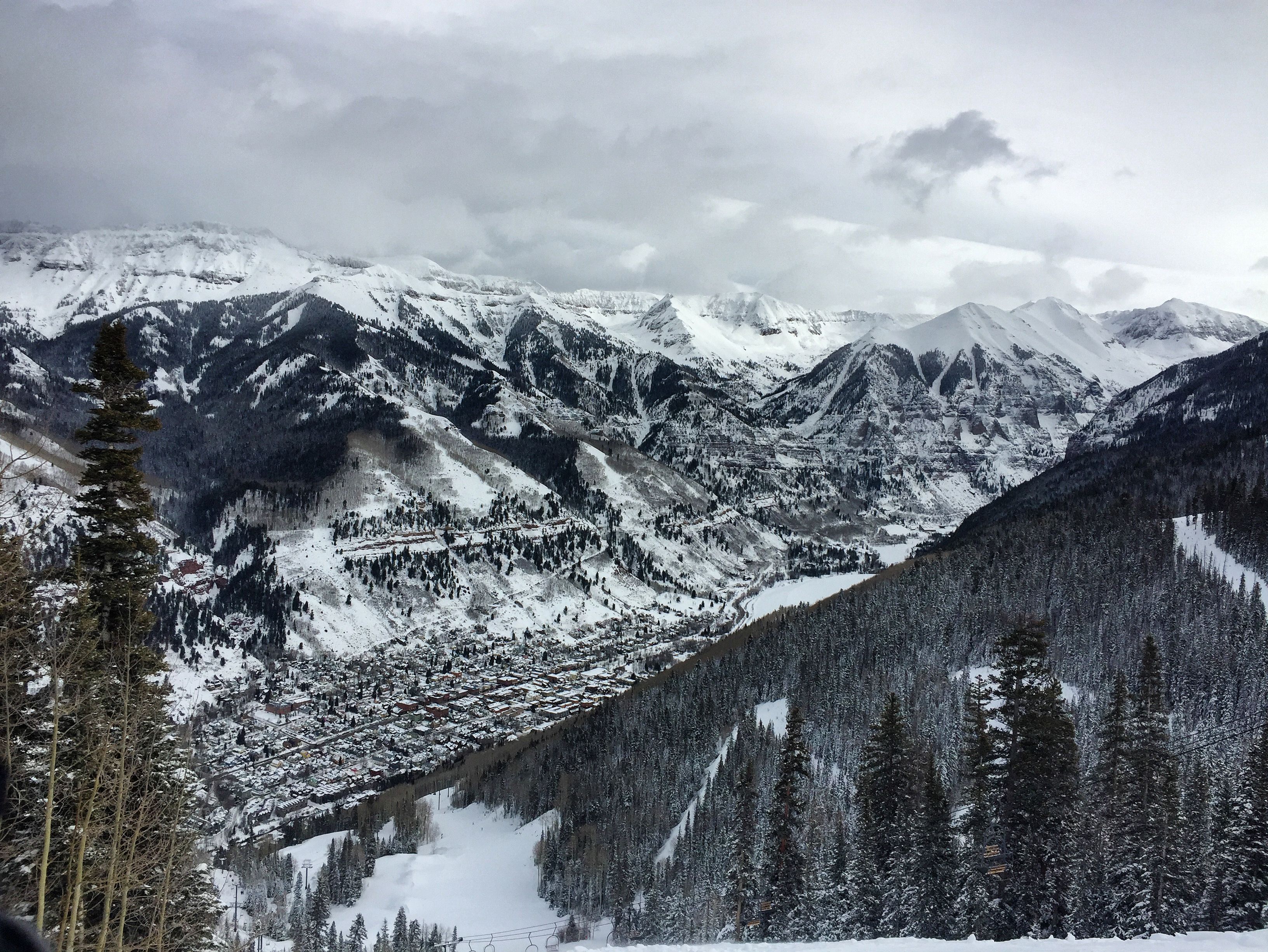 Snowcapped peaks and forest above Mountain Village, Colorado, next to Telluride.