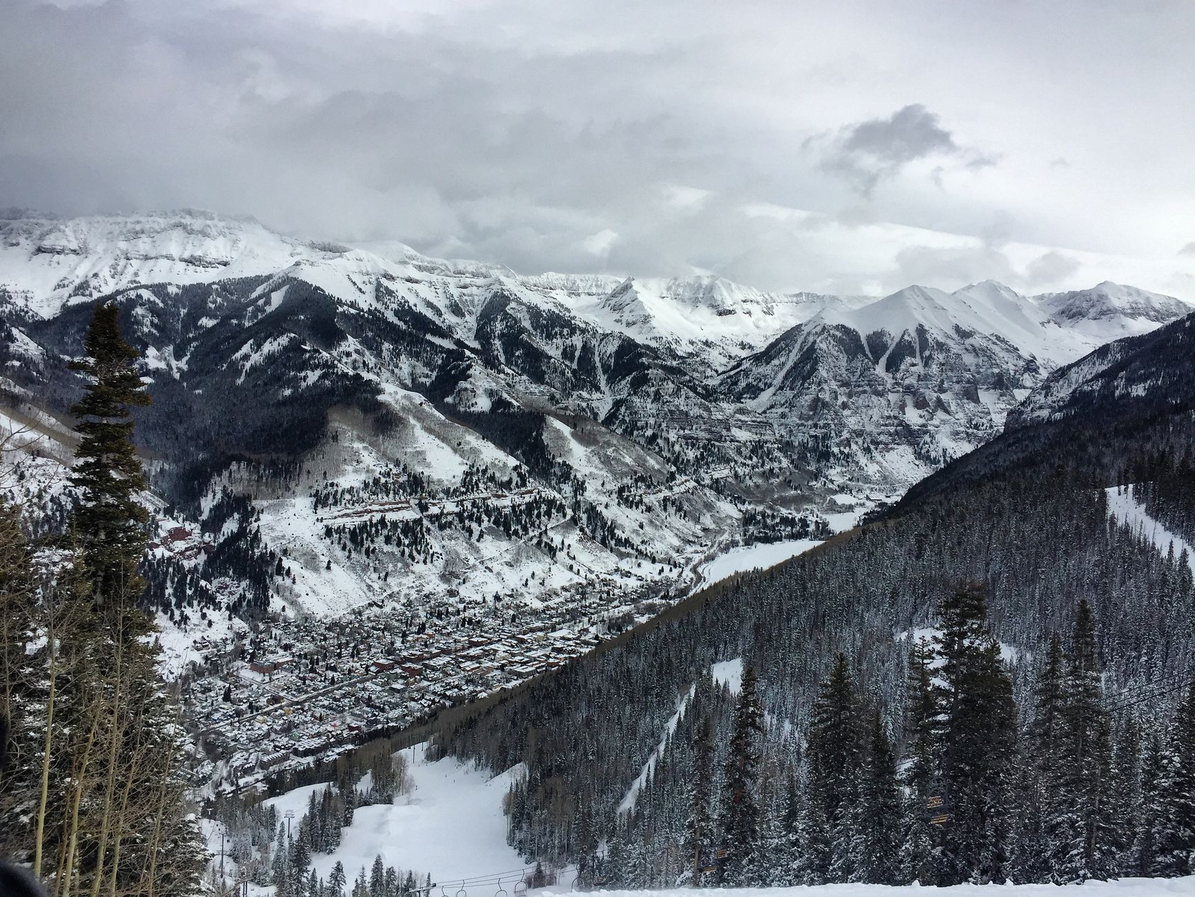 Snowcapped peaks and forest above Mountain Village, Colorado, next to Telluride.