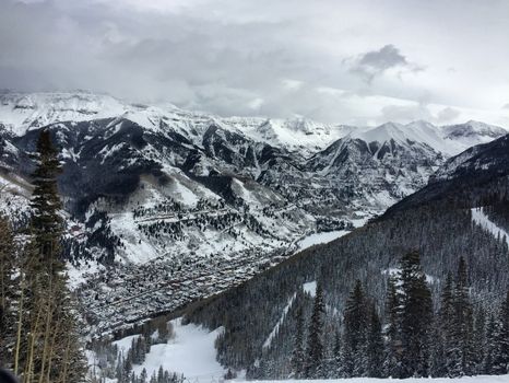 Breathtaking aerial view of snowcapped mountains and forest in Mountain Village, Colorado.