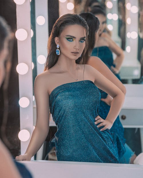 Woman in a Blue Dress Posing with Her Hand on Her Waist