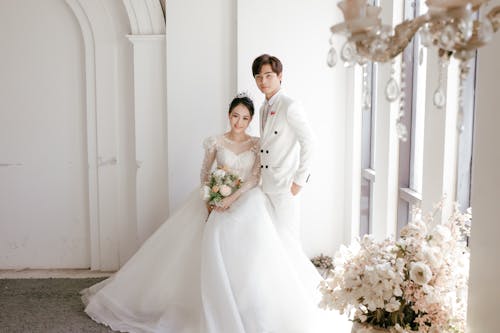 Free Romantic Asian newlyweds in fancy wedding studio Stock Photo
