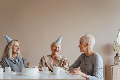 Three older women celebrating together indoors — photo by olia danilevich on Pexels