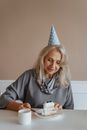 老妇人在生日庆祝活动中享用了一块蛋糕