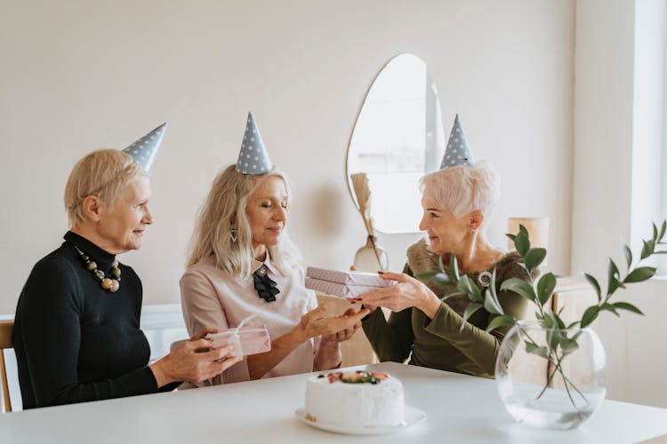 Photo Of An Elderly Woman Giving Gifts