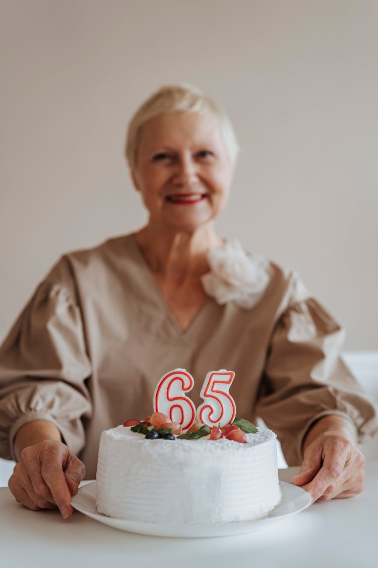 Photo Of A Birthday Cake Near An Elderly Woman