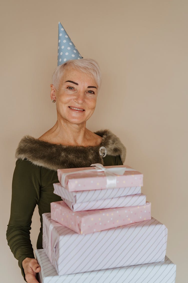 A Woman Holding A Stack Of Gifts 