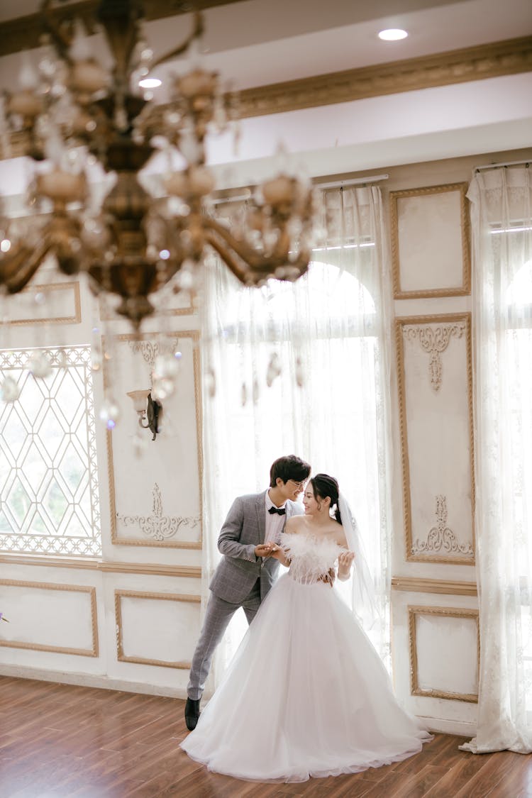 Elegant Asian Newlyweds In Spacious Ballroom