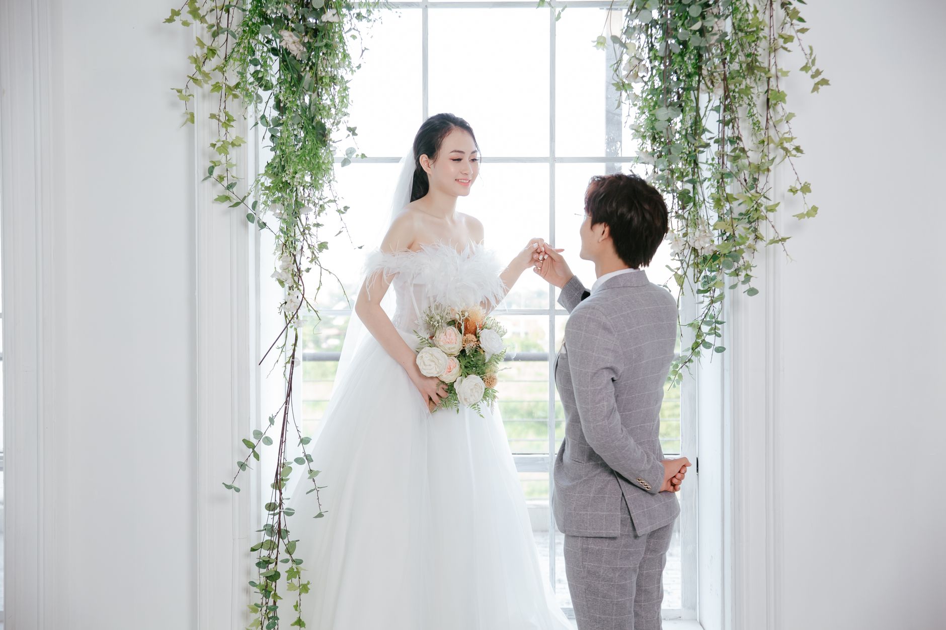 A joyful couple celebrates their wedding day in a beautifully decorated indoor setting.