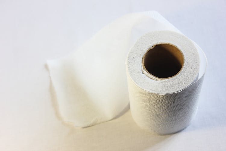 Close-up Of Toilet Paper Roll On White Background