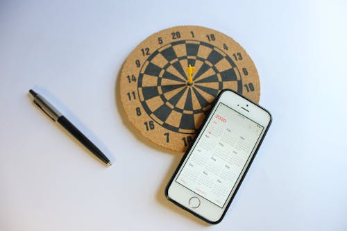 Free Mobile Phone and Darts on Table Stock Photo