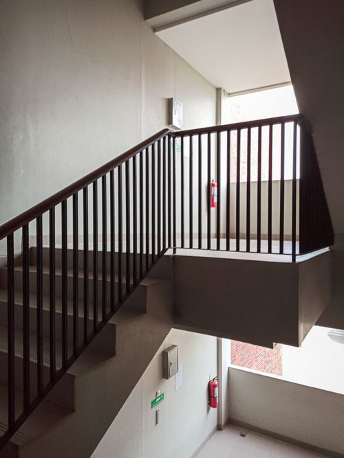 Free Interior of residential house with stairway with handrails and fire extinguishers on wall Stock Photo