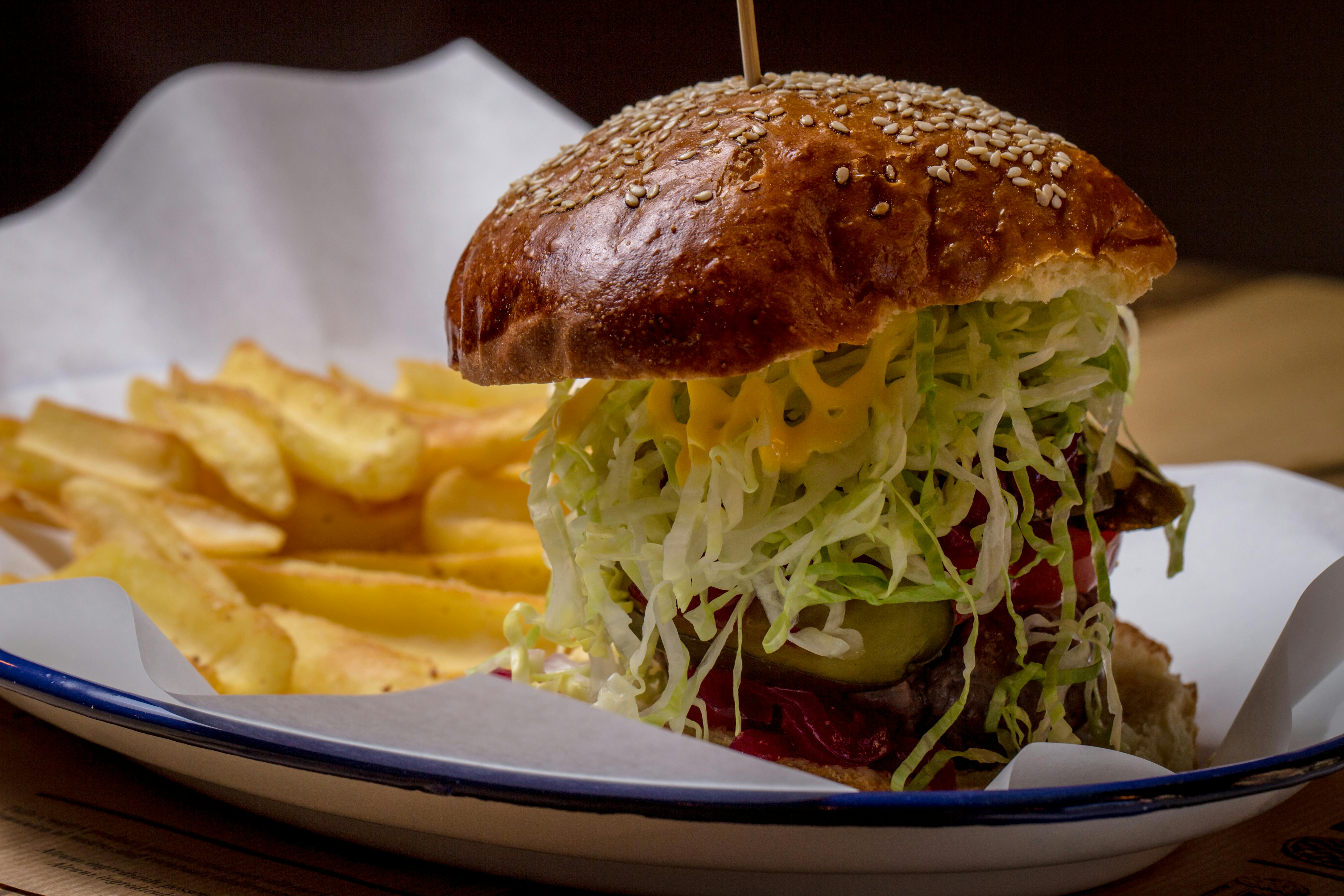 Selective Focus of Ham Burger on Wooden Surface Photo \u00b7 Free Stock Photo