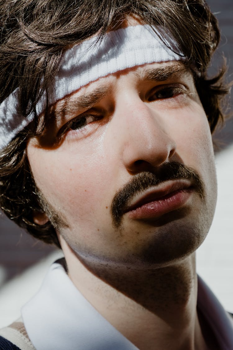 Close-up Of A Man Wearing A Sweatband