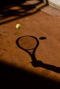 Shadows of Hand Holding Tennis Racket Hitting Ball