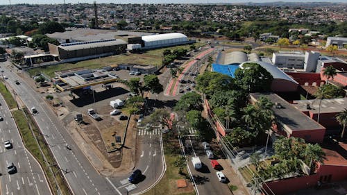 Aerial Shot of Buildings Beside a Road with Cars