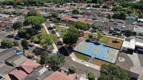 Aerial Shot of a Basketball Court Near Houses