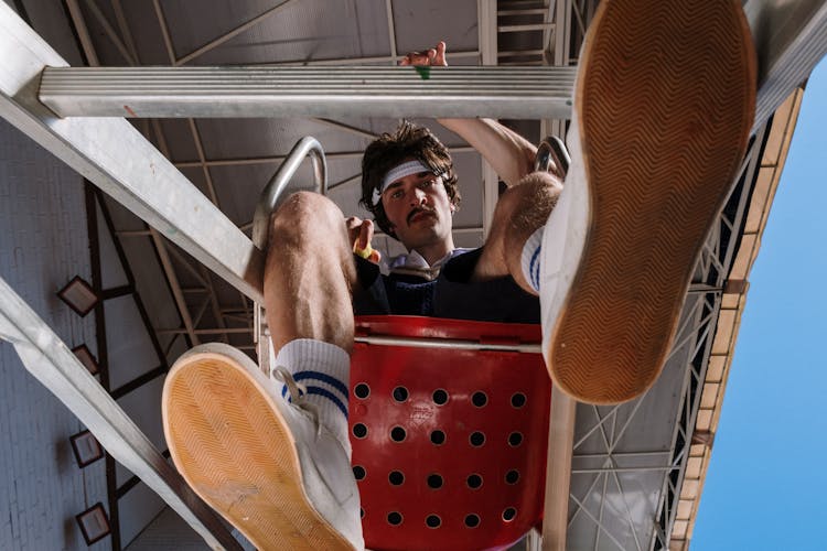 Low-Angle Shot Of  A Man With A White Sweatband Looking At The Camera