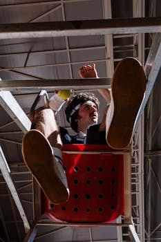 Low-angle view of a man in retro tennis attire sitting in a red chair, indoors.