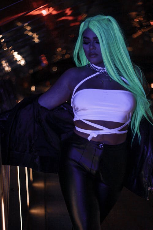 Photo of a Woman with Green Hair Wearing Black Leather Pants