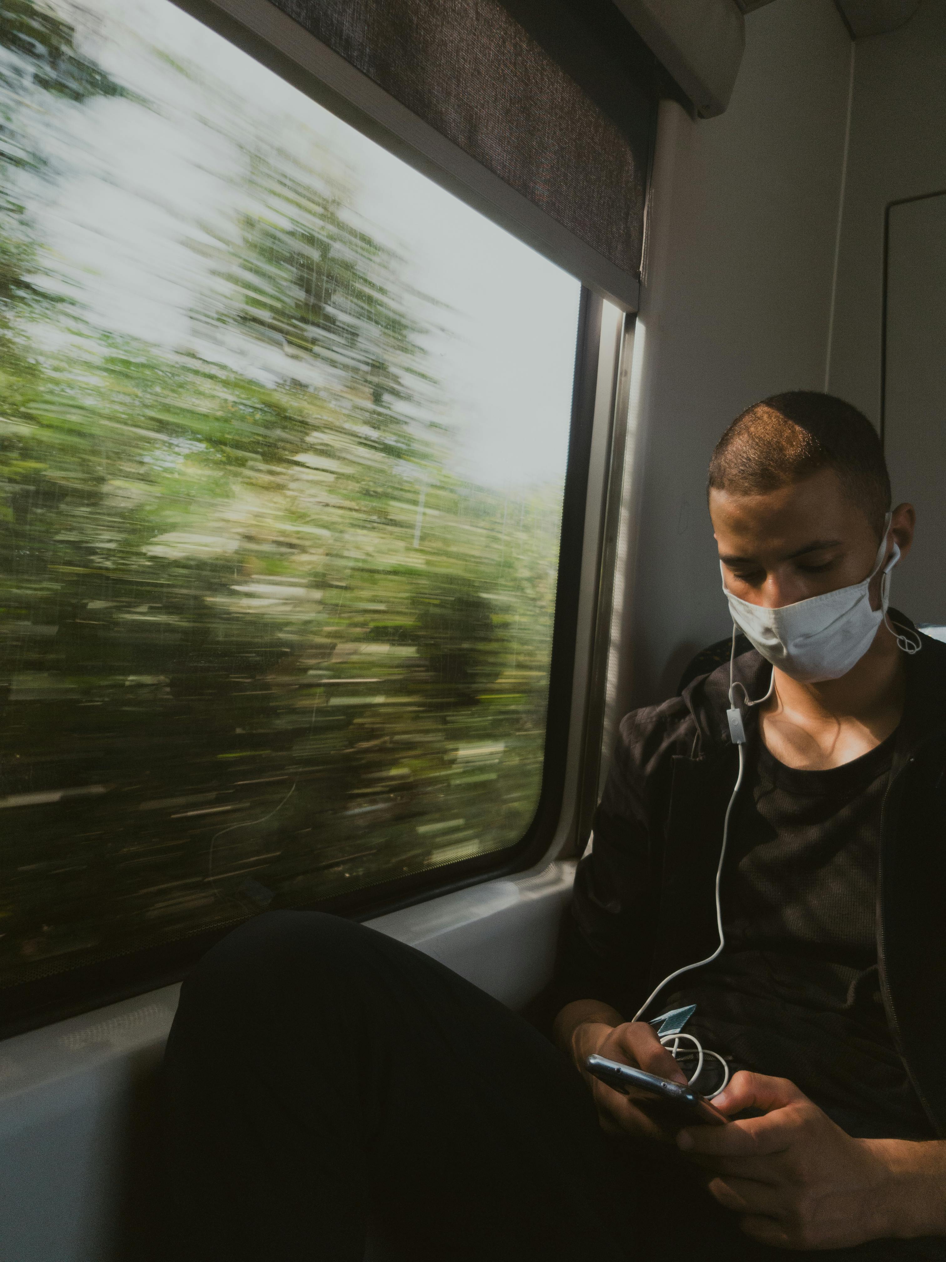 Young Man Looking Out Of Train Window Stock Photo - Download Image