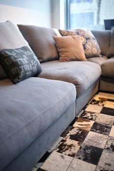 Comfortable grey couch with pillows