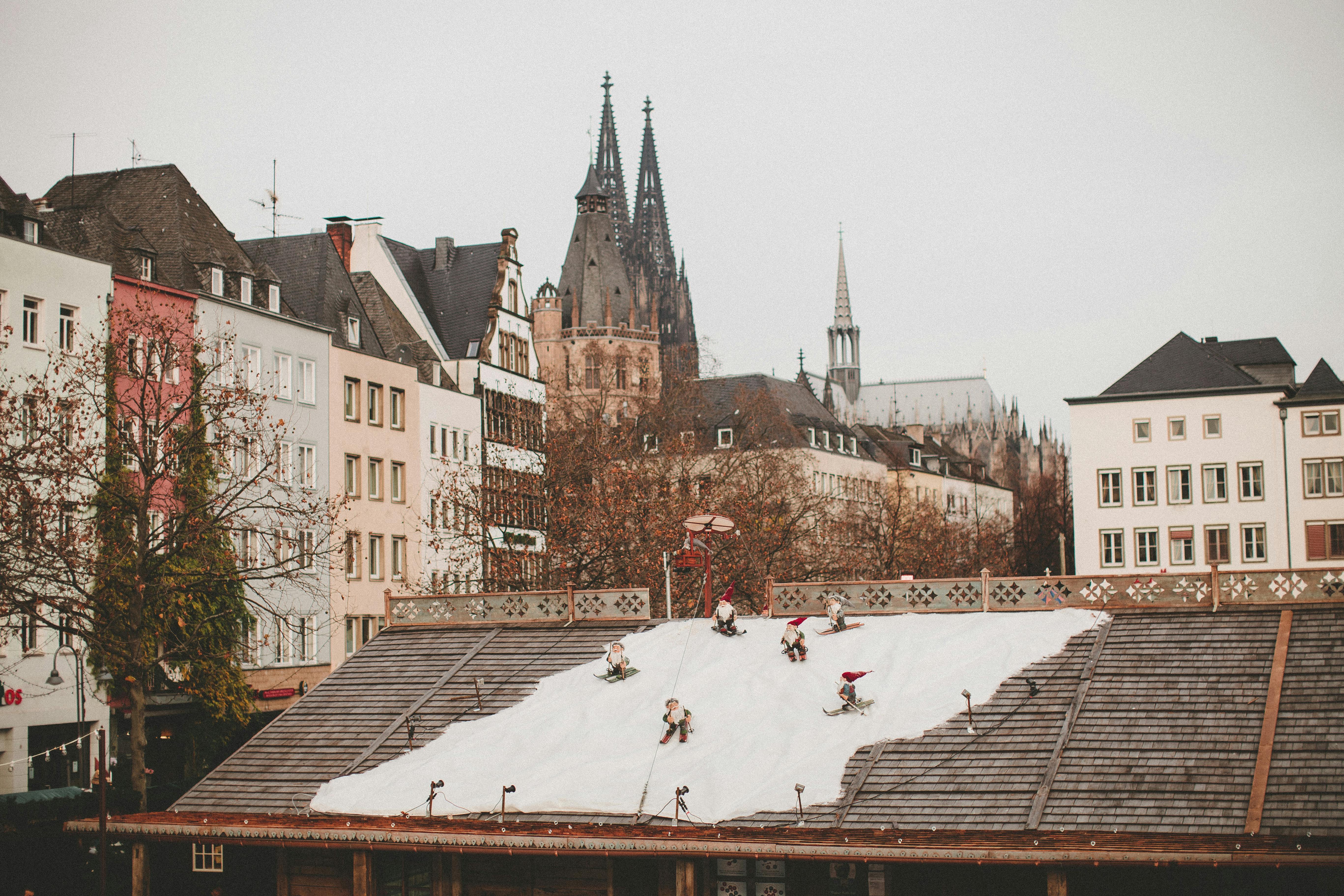 Charming urban winter scene with decorative snow and historical architecture.