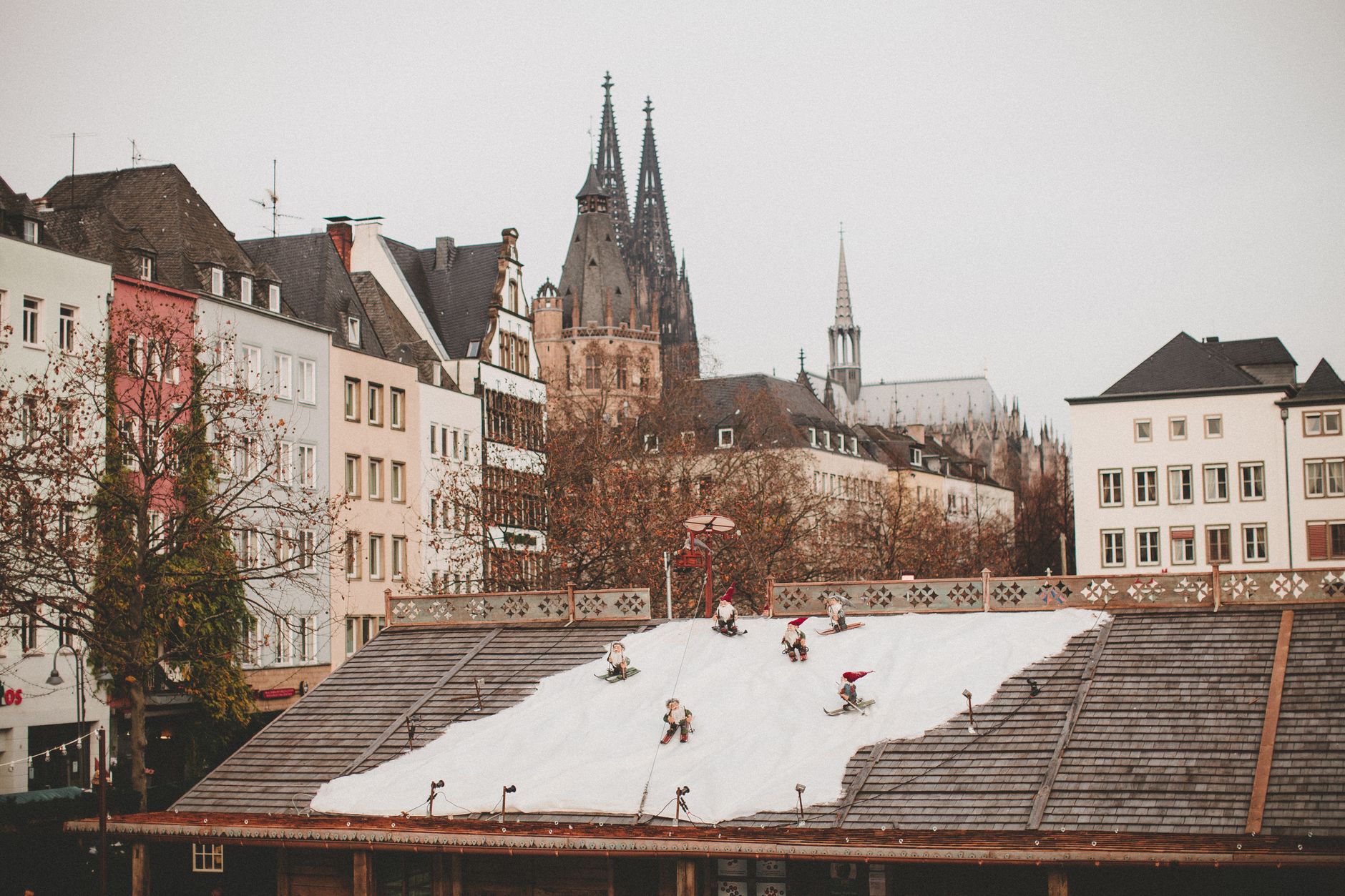 Charming urban winter scene with decorative snow and historical architecture.