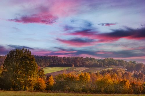 Free Vibrant sunset sky over the picturesque fields and forests of Kazimierz Dolny, Poland. Stock Photo
