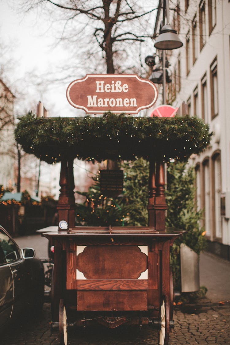 Photo Of A Brown Wooden Cart With A Red Sign