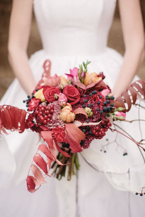 Photograph of a Woman Holding a Bridal Bouquet