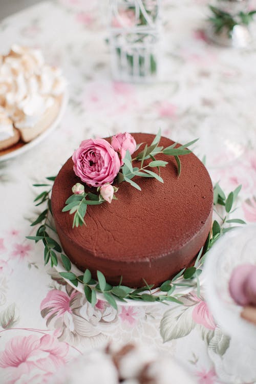 白とピンクの花のテーブルクロスにチョコレートケーキ