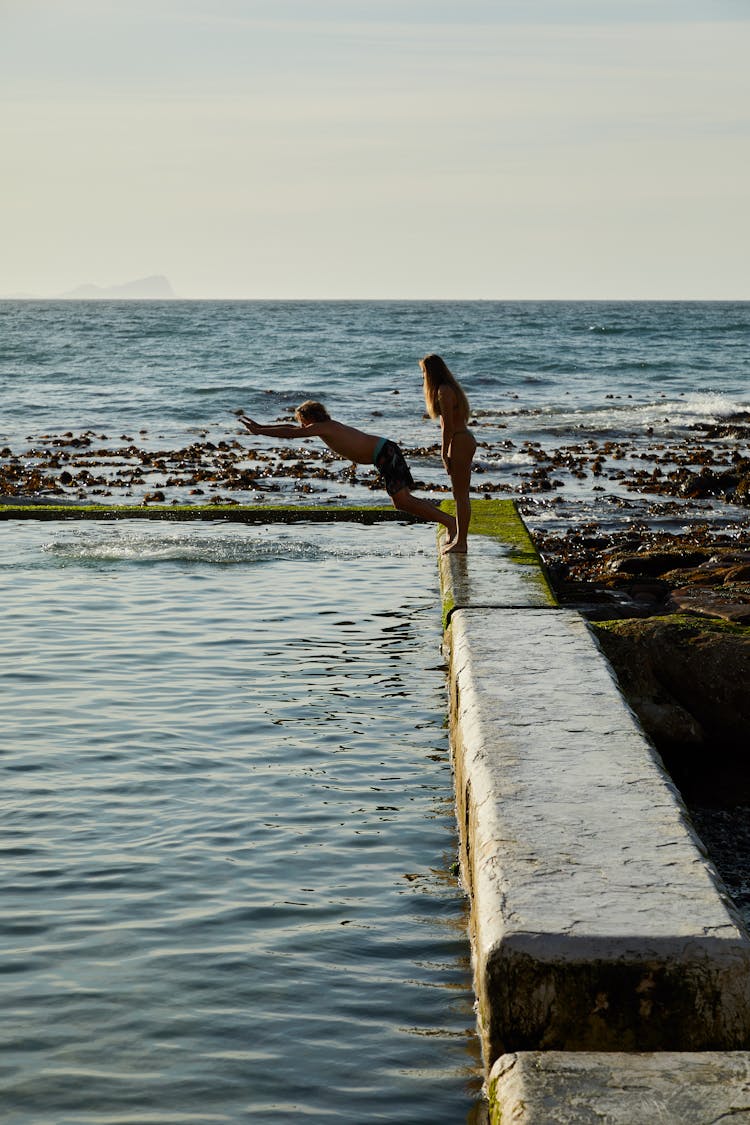 Photo Of A Kid Diving Into A Tidal Pool