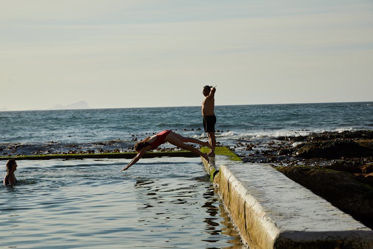 Photo Of A Woman Diving Into A Tidal Pool