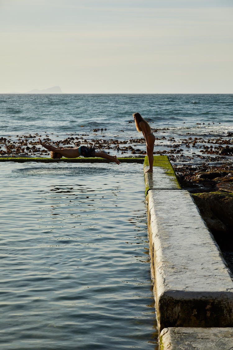 Man And Woman Swimming On Tidal Pool