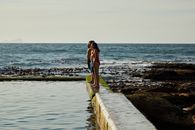 Photograph of People Standing Near a Tidal Pool