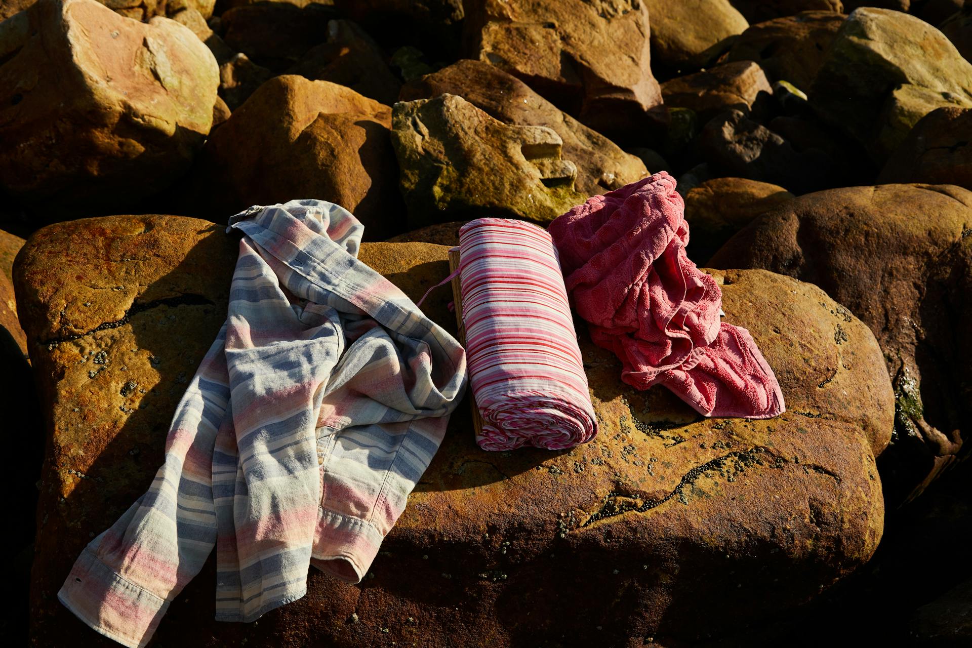 Photograph of a Shirt and Towels on a Rock