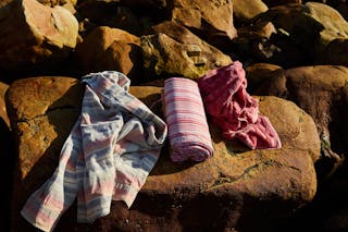 Photograph of a Shirt and Towels on a Rock