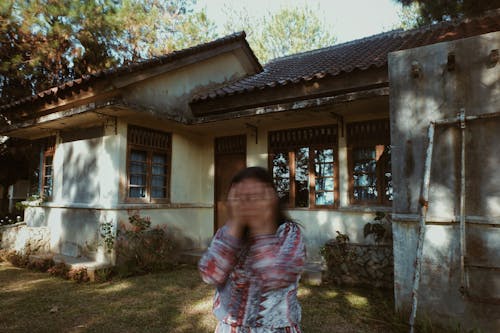 A Woman Standing Near the House