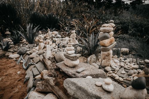 Free High angle of pyramids of stones placed near exotic green plants in tropical garden Stock Photo