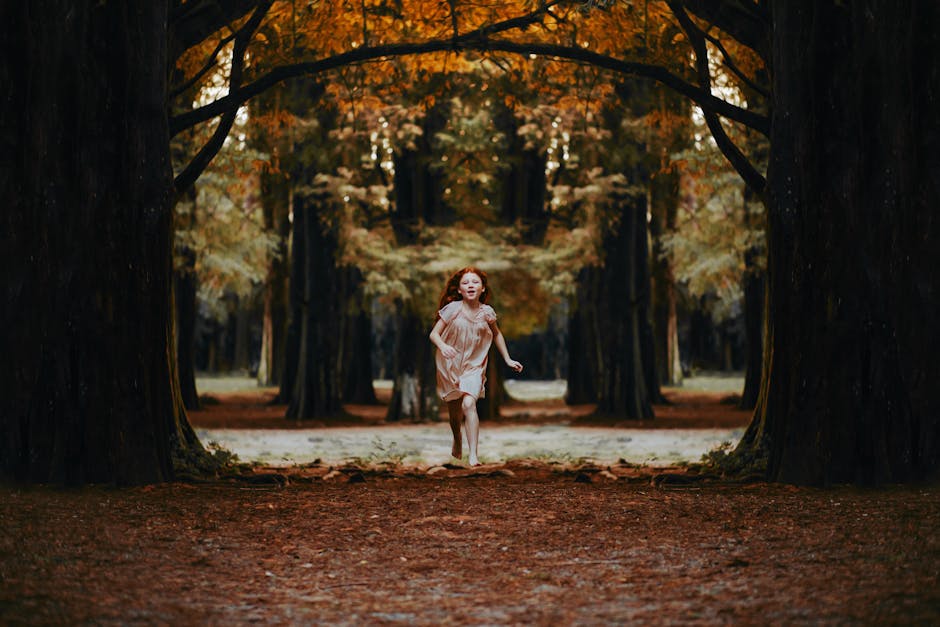 A young girl with red hair runs joyfully through a scenic autumn forest.