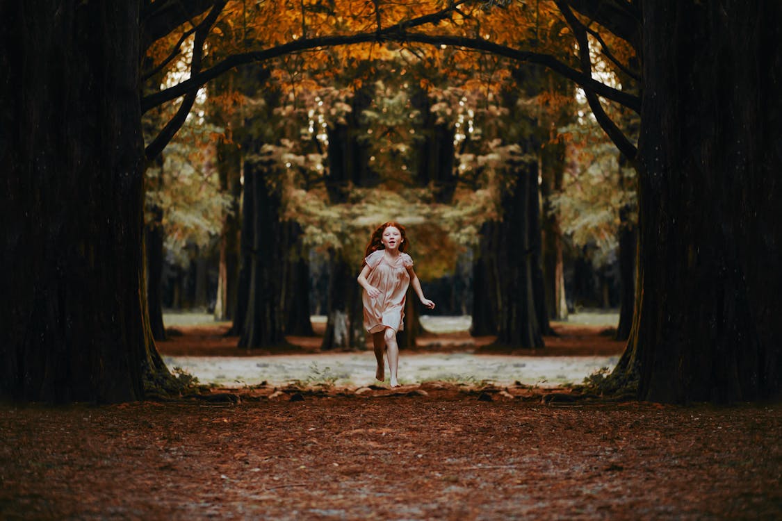 Free Girl Running Between Trees Stock Photo