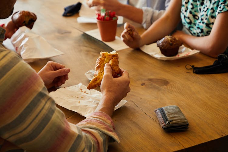 People Eating Pastry At A Table 