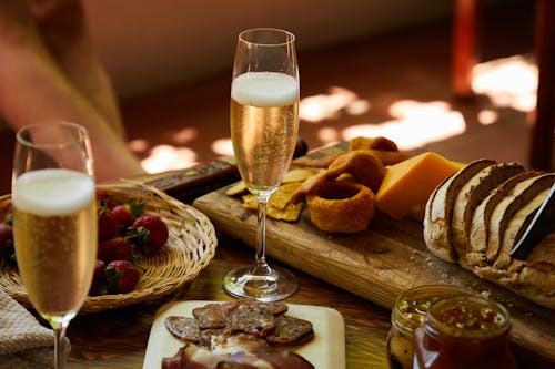 Free Close-Up Photo of Appetizers on a Charcuterie Board Near a Glass of Wine Stock Photo