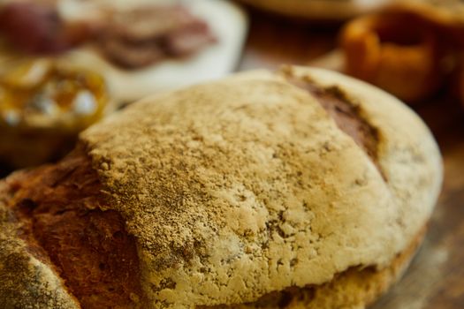 Freshly baked artisanal bread loaf with a rustic crust in a bakery setting.
