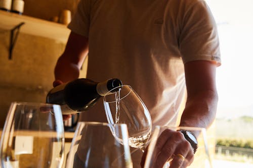 A Person Pouring Wine in the Glass