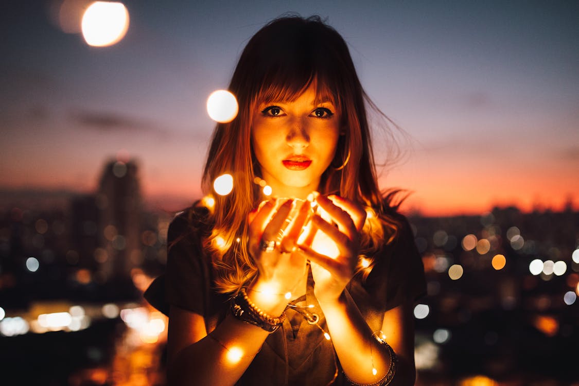 Free Woman Holding Fireflies Stock Photo