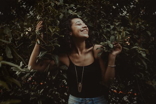 Free Woman Standing Behind Bush Stock Photo