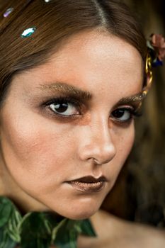 Close-up of a woman with creative makeup and dramatic look.