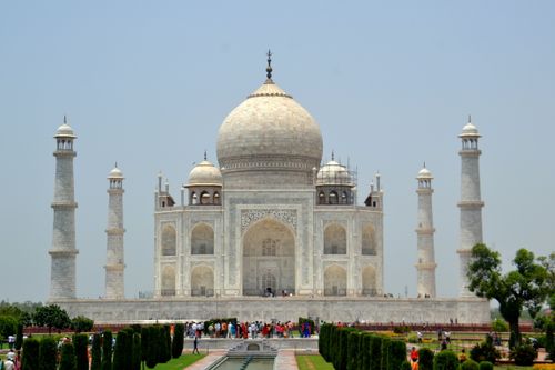 Free Majestic view of the Taj Mahal with tourists, showcasing its iconic architecture in Agra, India. Stock Photo