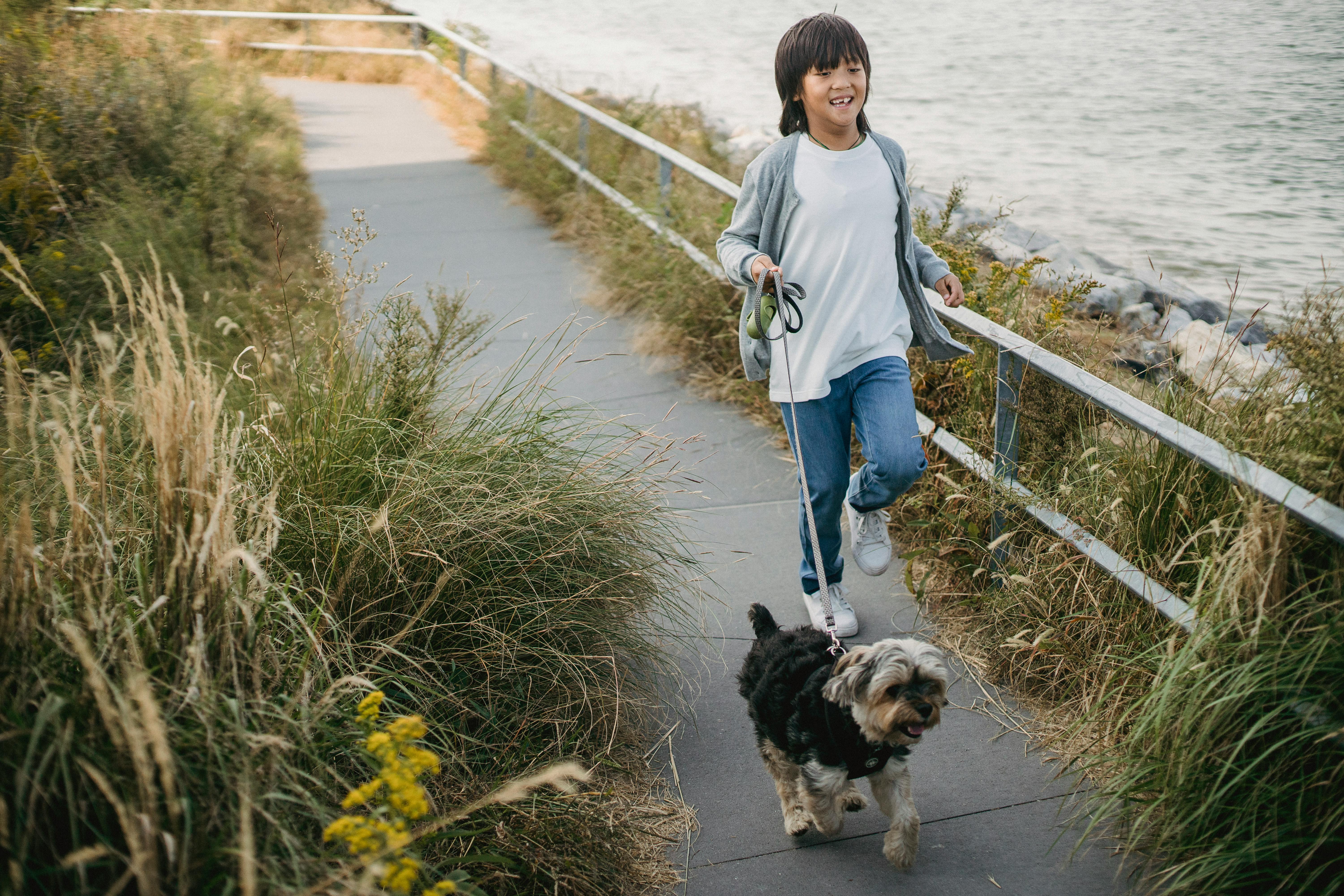 happy little boy running with puppy